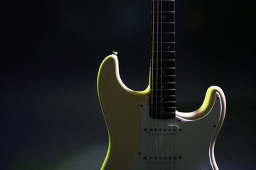 Obraz premium Part of electric guitar, on dark lighted background