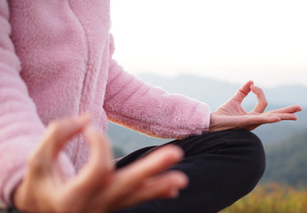 hand of a woman meditating in a yoga on the mountain