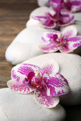 Fototapeta na wymiar Spa stones and orchids closeup
