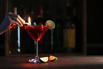 Burning cocktail and lime on table in a bar