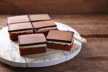 Delicious chocolate brownies on wooden background