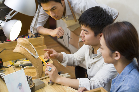 Jewelers talking in studio
