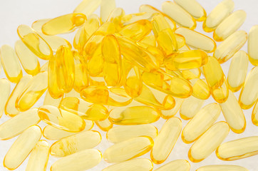 Capsule medical background, close up of pile of yellow blue tablets