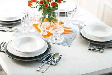 Served table with flowers in restaurant, closeup