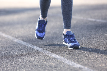 Sports woman legs in running movement