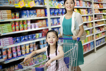 Mother and daughter shopping in supermarket