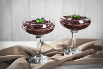 Chocolate mousse with fresh berries on wooden background