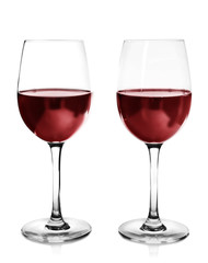 Two glasses of red wine on light background