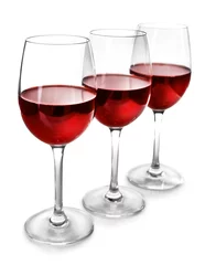 Fotobehang Three glasses of red wine on light background © Africa Studio