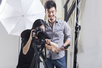Two photographers working in studio