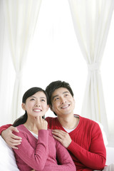 Young Chinese couple in living room