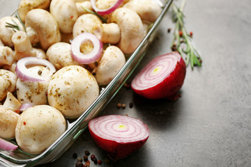Marinating mushrooms with spices on table, close up