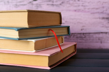 Pile of books on wooden background