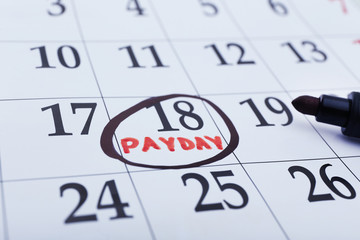 Payday concept. Calendar with black felt pen background. Date in frame, close up