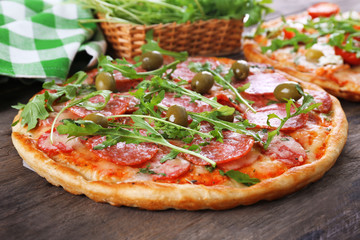 Delicious tasty pizza with ingredients on table, closeup