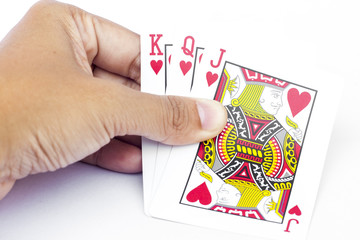 Playing cards in hand isolated on white background