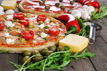 Delicious tasty pizza with ingredients on table, closeup