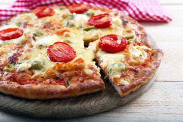 Delicious tasty pizza with cut slice, closeup