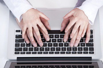 Fototapeta na wymiar Small hand on big hand, teaching how to use laptop