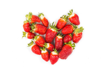Heaps of strawberries form heart shape on white background