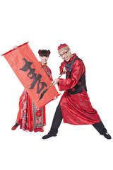 Happy couple in Tang suit practicing calligraphy