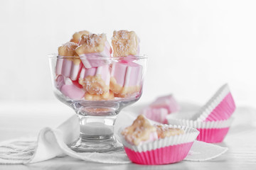 Tasty marshmallows with chocolate in bowl on table, close up