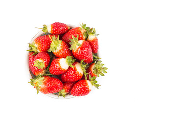Plateful of freshly harvested organic strawberries with white background