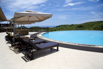 Swimming pool, lounge chairs and umbrellas