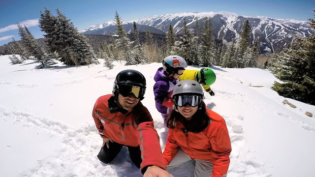portrait young Caucasian family parents boy girl outdoor snow ski resort sport