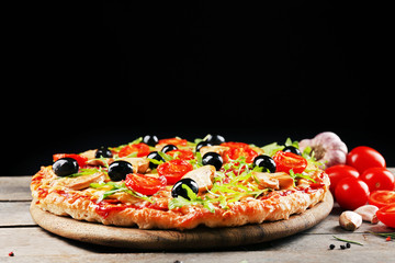 Delicious tasty pizza on black background
