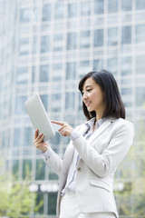 Young businesswoman using digital tablet