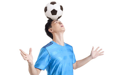 Soccer player balancing a ball on his head