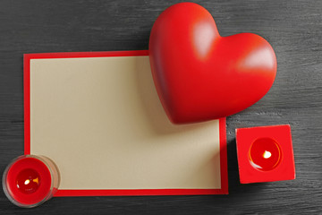 Card and St Valentine's decor on wooden background