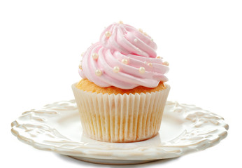 Pink cupcake on plate isolated on white