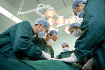 Team of surgeons working in an operating room