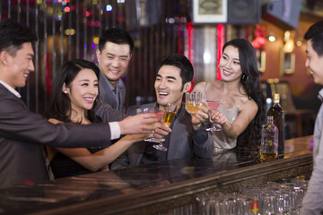 Friends toasting in bar