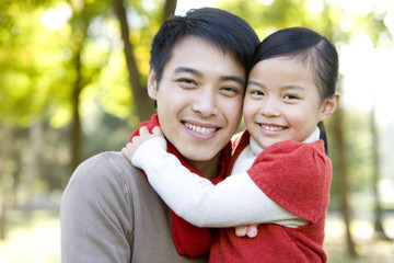 Father and Daughter Enjoying a Park in Autumn