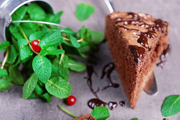 Pile of mint and slice of chocolate pie, closeup