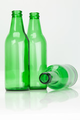 Empty Green Beer Bottles With One On Its Side