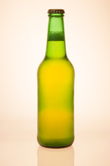 Backlit Green Beer Bottle With Yellowish Glow On White Background