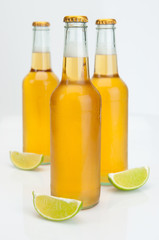 Cerveza Beer Bottles With Limes On White Background Closeup