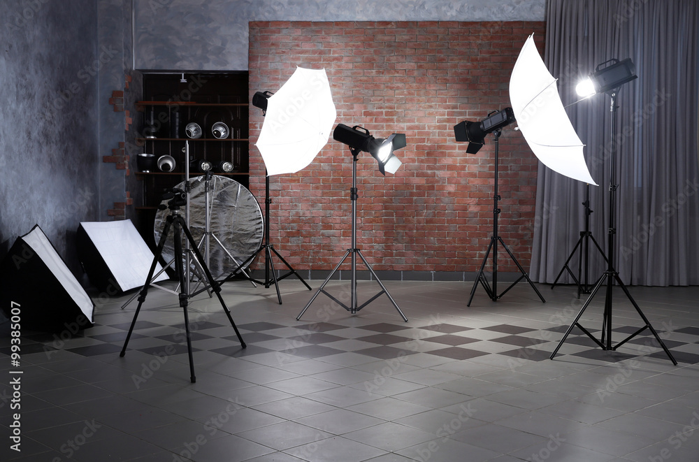 Wall mural Empty photo studio with lighting equipment