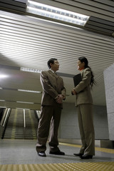 Businessman And Businesswoman Having A Discussion