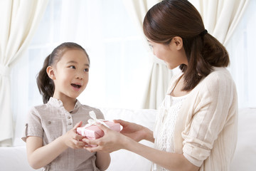 Mother and daughter exchanging gifts