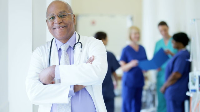 Portrait of confident African American male senior doctor in medical centre