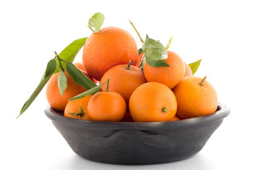 Tangerines on clay bowl