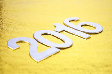 selective focus of 2016 number over golden background