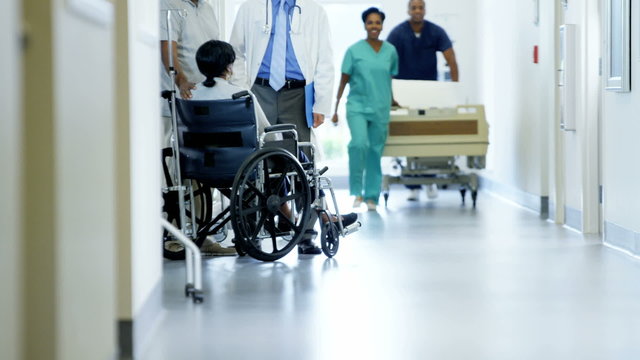 African American couple female on wheelchair consult with doctor in hospital