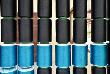 Black and blue silk thread spool