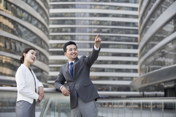 Business person pointing and looking at view